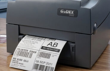Label printer in a laboratory printing donor blood labels with barcodes and 'AB Rh Negative' blood type